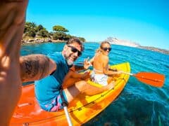 Travellers kayaking in tropical water